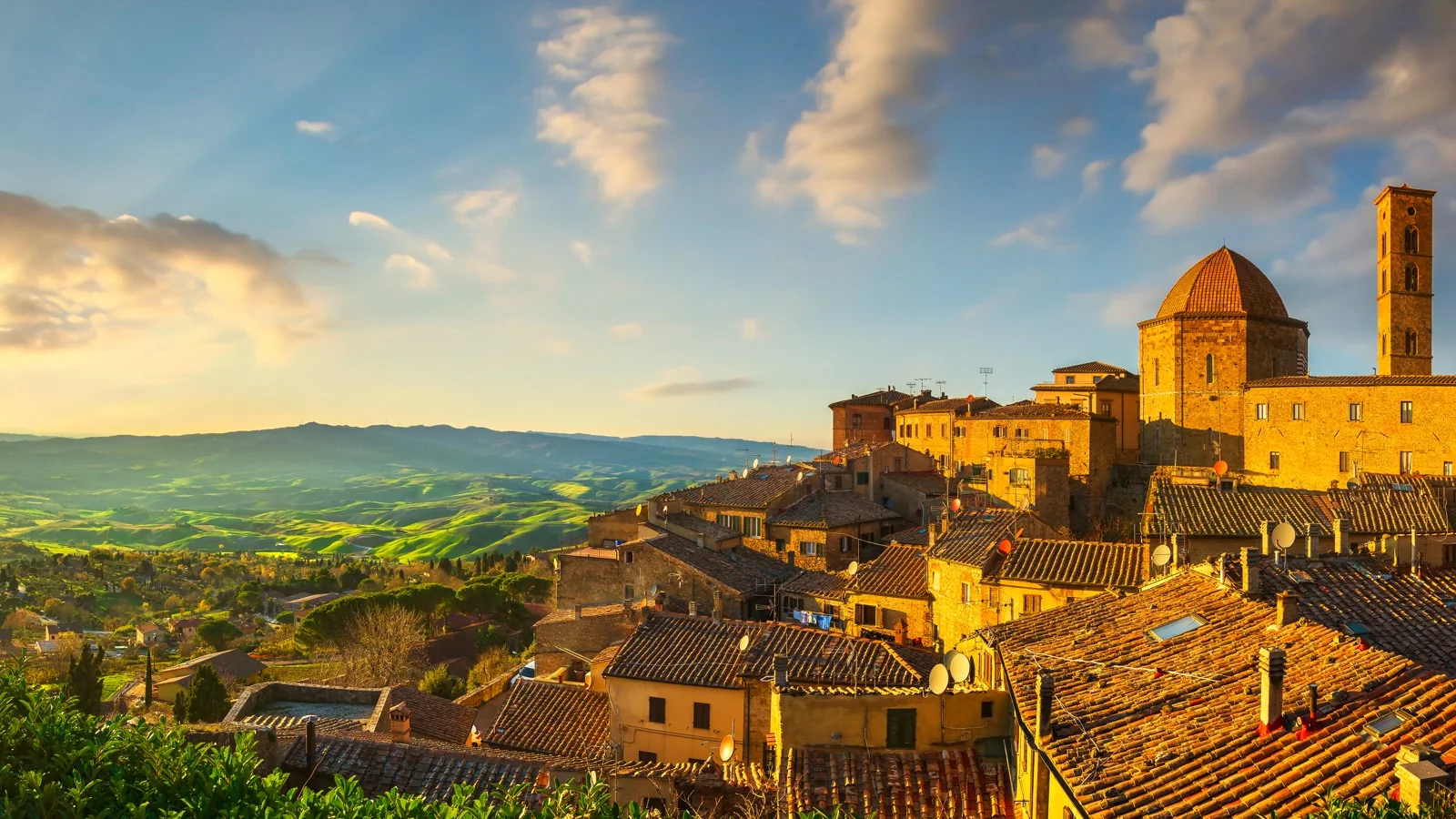 Volterra historic centre overlooking the Tuscan countryside in golden-hour light